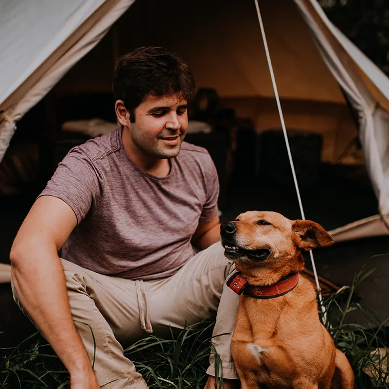 Man Camping With Dog